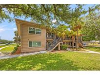 Two-story multi-Gathering building with manicured landscaping and a welcoming staircase to the units at 232 36Th N Ave # 202C, St Petersburg, FL 33704