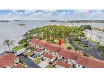 Beautiful aerial view of townhomes with red tile roofs near waterfront and lush green trees at 2700 Bayshore Blvd # 497, Dunedin, FL 34698