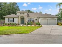 Charming single-story home with manicured lawn, inviting entrance, and two-car garage at 2901 Laurel Meadow Ct, Plant City, FL 33566