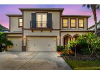 Beautiful two-story home with a three car garage, balcony and meticulously maintained landscaping at 4089 Windcrest Dr, Wesley Chapel, FL 33544