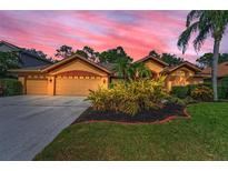 Beautiful single-Gathering home with a three-car garage and meticulously landscaped front yard at 4133 Auston Way, Palm Harbor, FL 34685