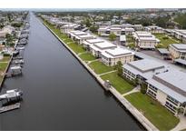 Scenic aerial view of waterfront condo community featuring boat docks and lush landscaping at 4812 Jasper Dr # 203, New Port Richey, FL 34652