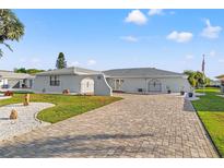 Charming single-story home with a brick driveway and well-maintained landscaping at 629 Fort Duquesna Dr, Sun City Center, FL 33573