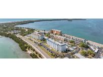 A complex of apartment buildings with one painted white with a blue roof, located in a coastal setting at 7 Elgin Pl # 202, Dunedin, FL 34698