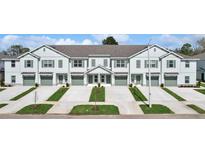 Charming townhomes feature private garages, driveways, and inviting landscaping enhancing curb appeal at 11742 Blackbrook Ct, Seffner, FL 33584