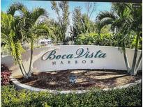 Boca Vista Harbor community entrance sign surrounded by lush landscaping and palm trees at 13313 Gasparilla Rd # 401, Placida, FL 33946
