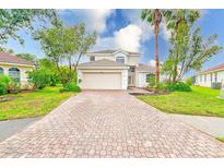 Two-story home features a driveway and manicured lawn at 2424 Caraway Dr, Venice, FL 34292