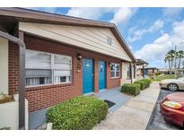 Charming exterior showing colorful doors, brickwork, and well-maintained landscaping, with parking at 24862 Us Highway 19 N # 1105, Clearwater, FL 33763