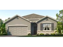 Charming single-story home with a two-car garage, stone accents, and a well-manicured lawn at 3503 Capital Reserve Dr, Plant City, FL 33565