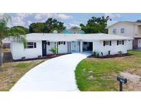 Charming single-story home featuring a white brick facade and well-maintained landscaping at 6304 Memorial Hwy, Tampa, FL 33615
