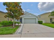 Charming single-Gathering home with a well-maintained lawn and a two-car garage at 6512 Trent Creek Dr, Sun City Center, FL 33573