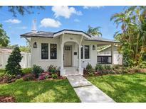 Charming home featuring a well-manicured lawn, fresh landscaping, and a welcoming walkway to the front door at 791 44Th N Ave, St Petersburg, FL 33703