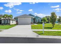Charming single Gathering home with well-manicured lawn and two-car garage, situated on a sunny lot at 11016 Kiskadee Cir, New Port Richey, FL 34654