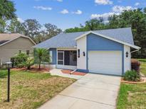 Charming single-Gathering home with a well-manicured lawn and attached two-car garage at 11628 Aspenwood Dr, New Port Richey, FL 34654