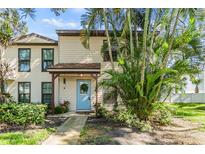 Charming two-story home with a light blue door and well-maintained landscaping at 1515 Bayshore Blvd # 38, Dunedin, FL 34698