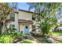 Charming home with a blue door and lush, tropical landscaping at 1515 Bayshore Blvd # 38, Dunedin, FL 34698