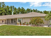 Charming single-story home with well-manicured lawn, mature landscaping, and screened in lanai at 1604 Comfy Ct, Sun City Center, FL 33573
