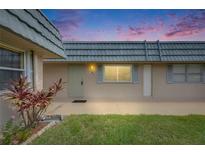 Charming home featuring a well-maintained front yard and a tranquil exterior view at dusk at 1802 Bedford Ter # 185, Sun City Center, FL 33573