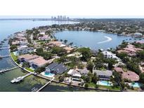 Stunning aerial view of waterfront homes with pools and private docks on a sunny day at 1967 Brightwaters Ne Blvd, St Petersburg, FL 33704