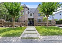 Stunning home boasts mature trees, lush lawn, and a secure gated entrance, creating an inviting curb appeal at 2902 W Fair Oaks Ave, Tampa, FL 33611