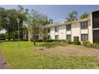 Inviting two-story condo with a well-manicured lawn and lush landscaping at 3114 Lake Pine Way # G1, Tarpon Springs, FL 34688