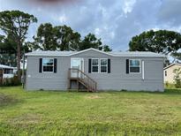 Charming single-story home featuring a well-maintained lawn and classic gray siding with black shutters at 3221 Roxborough Ave, Clearwater, FL 33762
