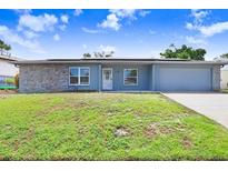 Charming single-story home featuring a stone accent wall and a well-manicured lawn in a residential neighborhood at 3917 Casaba Loop, Valrico, FL 33596