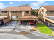 Inviting condo with covered parking, lush landscaping, and classic architectural details at 4036 Davit Dr, New Port Richey, FL 34652