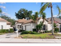 Charming single-story home featuring a well-manicured lawn, mature trees, and a two-car garage at 5117 Fairway One Dr, Valrico, FL 33596