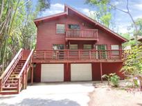 Two story home featuring a balcony, a two car garage, and a wooden deck at 5736 116Th N Ave, Pinellas Park, FL 33782