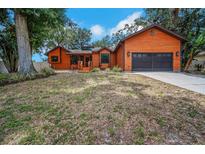 Charming one-story home featuring a two-car garage, inviting front porch, and well-maintained lawn at 1004 Black Knight Dr, Valrico, FL 33594