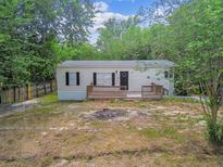 Exterior of home features a small porch at 10537 Fran St, New Port Richey, FL 34654