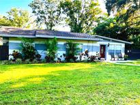 Charming single-story home featuring mature landscaping and a freshly manicured lawn at 11107 Riverview Dr, Riverview, FL 33578