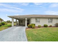 Charming single-story home featuring a well-maintained lawn and inviting carport at 2214 Highclere Cir # 6, Sun City Center, FL 33573