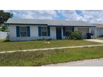 Charming single-story home with blue shutters and a well-maintained lawn at 2603 Mary Sue Sw St, Largo, FL 33774