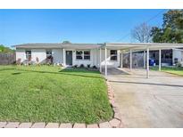 Charming one-story home with a well-manicured lawn and brick-lined landscaping at 3209 W Tyson Ave, Tampa, FL 33611
