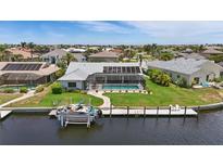 Waterfront home featuring a private boat dock, screened lanai, and refreshing pool at 3936 Crooked Island Dr, Punta Gorda, FL 33950