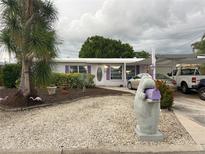 Charming single story home with lovely landscaping, a unique mailbox, and covered parking at 405 Bryn Mawr Is, Bradenton, FL 34207