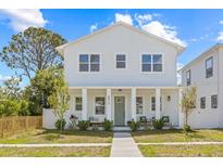 Charming two-story home with light blue exterior, inviting front porch, and well-manicured lawn at 4513 21St N St, St Petersburg, FL 33714