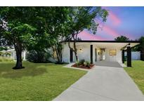 Charming single-story home with a well-manicured lawn and covered entryway, perfect for suburban living at 6551 S West Shore Cir, Tampa, FL 33616