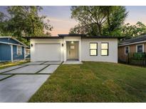 Charming single-story home boasts a freshly painted exterior, a new roof, and a well-maintained yard at 8112 N 10Th St, Tampa, FL 33604