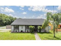 Charming single-story home featuring manicured landscaping and a welcoming entrance at 16023 Splitlog Dr, Tampa, FL 33618