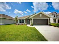 Charming single-Gathering home featuring a well-manicured lawn, and a two-car garage at 16503 66Th E Ln, Parrish, FL 34219