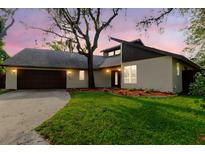 Charming single-Gathering home with a well-manicured lawn and beautiful mature landscaping at 1974 Hidden Springs Pl, Clearwater, FL 33760
