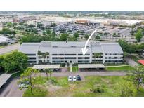 Condo building featuring well-maintained landscaping, covered parking, and proximity to shopping centers at 2581 Countryside Blvd # 2309, Clearwater, FL 33761