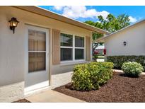 Charming single-story home featuring a well-maintained front garden with green bushes and a welcoming entrance at 3146 37Th S Ln # A, St Petersburg, FL 33711