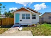 Charming bungalow featuring a light blue front door and well-maintained landscaping at 3230 4Th S Ave, St Petersburg, FL 33712