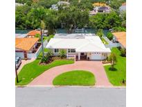 Charming home featuring a well manicured lawn, beautiful landscaping, and a brick circular driveway at 715 45Th Ne Ave, St Petersburg, FL 33703