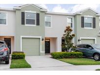 Charming townhome featuring a one-car garage, and nicely manicured landscaping at 11054 Crescent Deer Dr, Land O Lakes, FL 34638