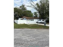 Charming home with a well-maintained yard and a white picket fence, providing a cozy and inviting curb appeal at 12502 Cambridge Ave, Tampa, FL 33624